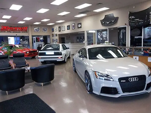 The 2Bennett showroom with a white Audi TT RS and a white Ur-quattro inside
